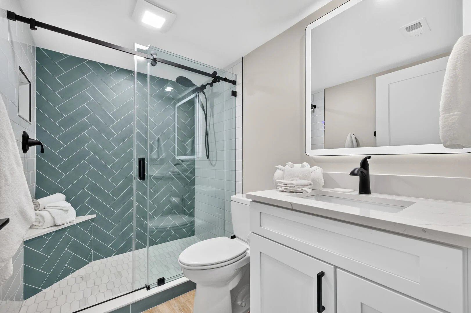 Guest bathroom with teal herringbone tile