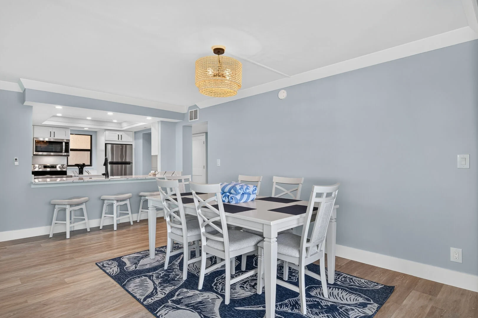 Dining room with chandelier and kitchen pass-through